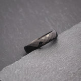Elegant black tungsten wedding band with faceted design for women