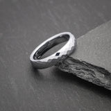 Elegant simple silver wedding band with light-reflecting facets