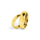 His and hers gold wedding rings set on white background