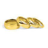 Comfort fit gold wedding bands for couples on white backdrop