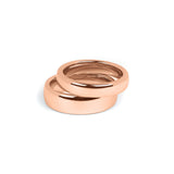 Set of matching rose gold wedding rings for engaged couples, polished and durable