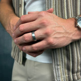 man wearing a brushed silver tungsten wedding ring