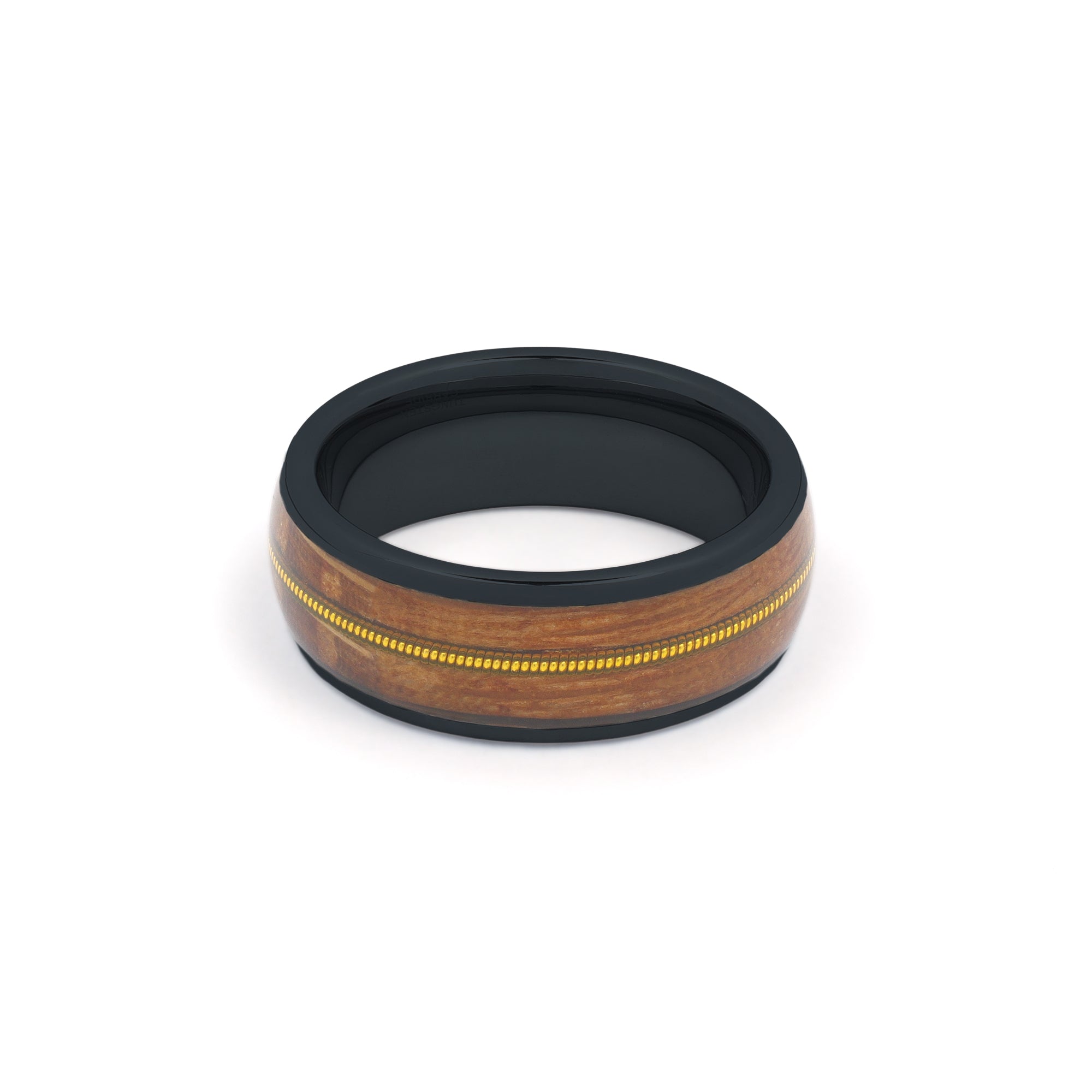 black tungsten ring featuring a recycled guitar wood and string inlay, laying flat on a white surface