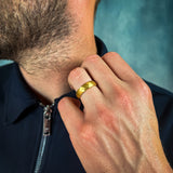 a man wearing a gold hammered tungsten wedding band