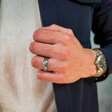 a man wearing a hammered grey tungsten wedding band