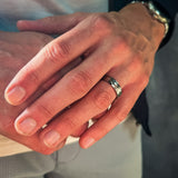 a man wearing a hammered grey tungsten wedding band