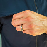 a man wearing a hammered grey and gold two tone tungsten wedding band