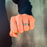 man wearing a hammered grey and rose gold tungsten wedding band