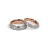 couple wedding rings with modern hammered texture on white background