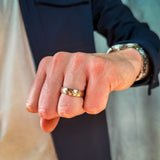 a man wearing a rose gold hammered tungsten wedding band