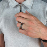 Person wearing a light gray polo shirt with a close-up of a hand adjusting the collar.