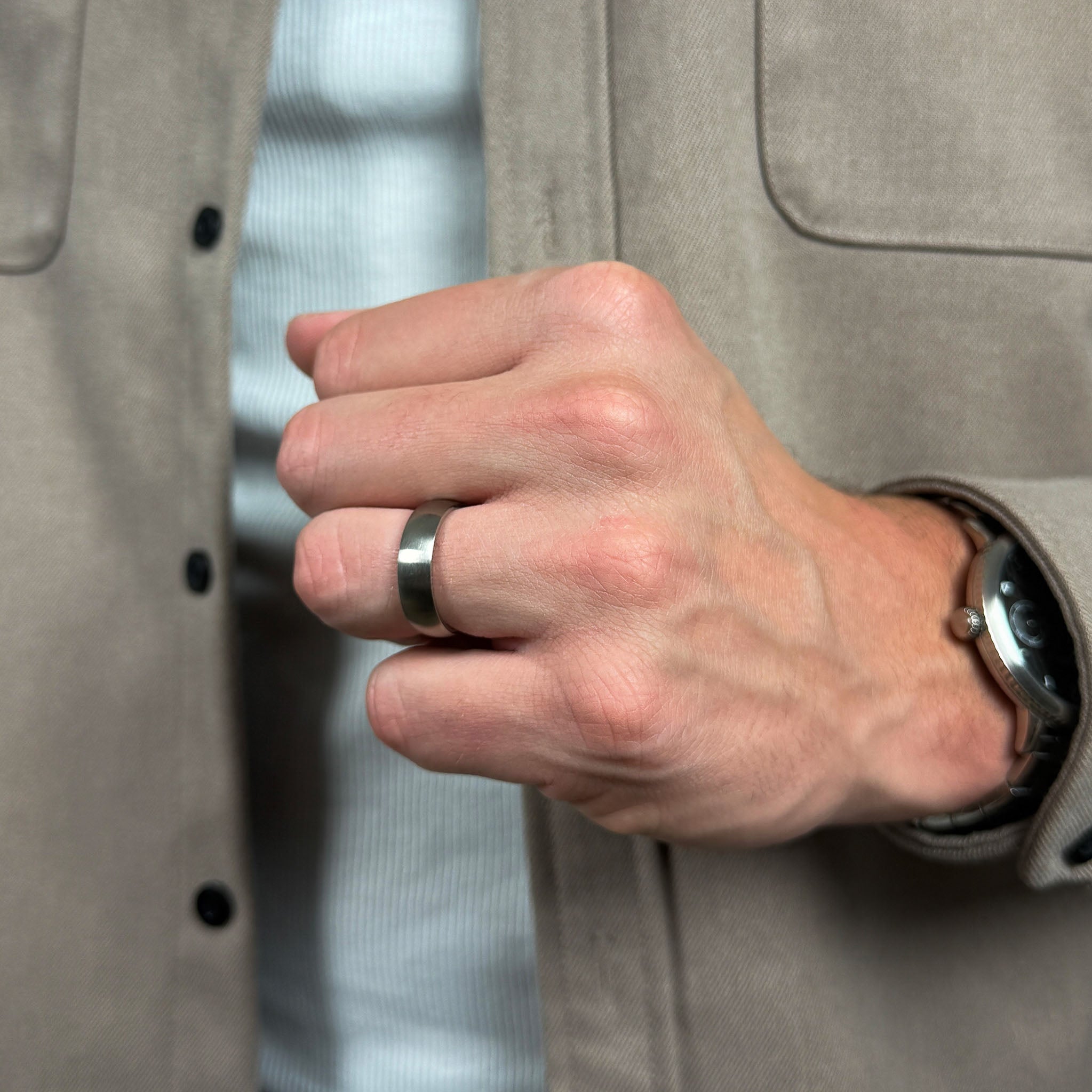 a man clenching his fist showing off his titanium ring for men