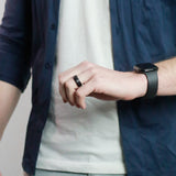 side view of a man wearing a black tungsten wedding ring