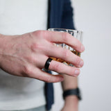 man wearing a beveled black tungsten wedding ring
