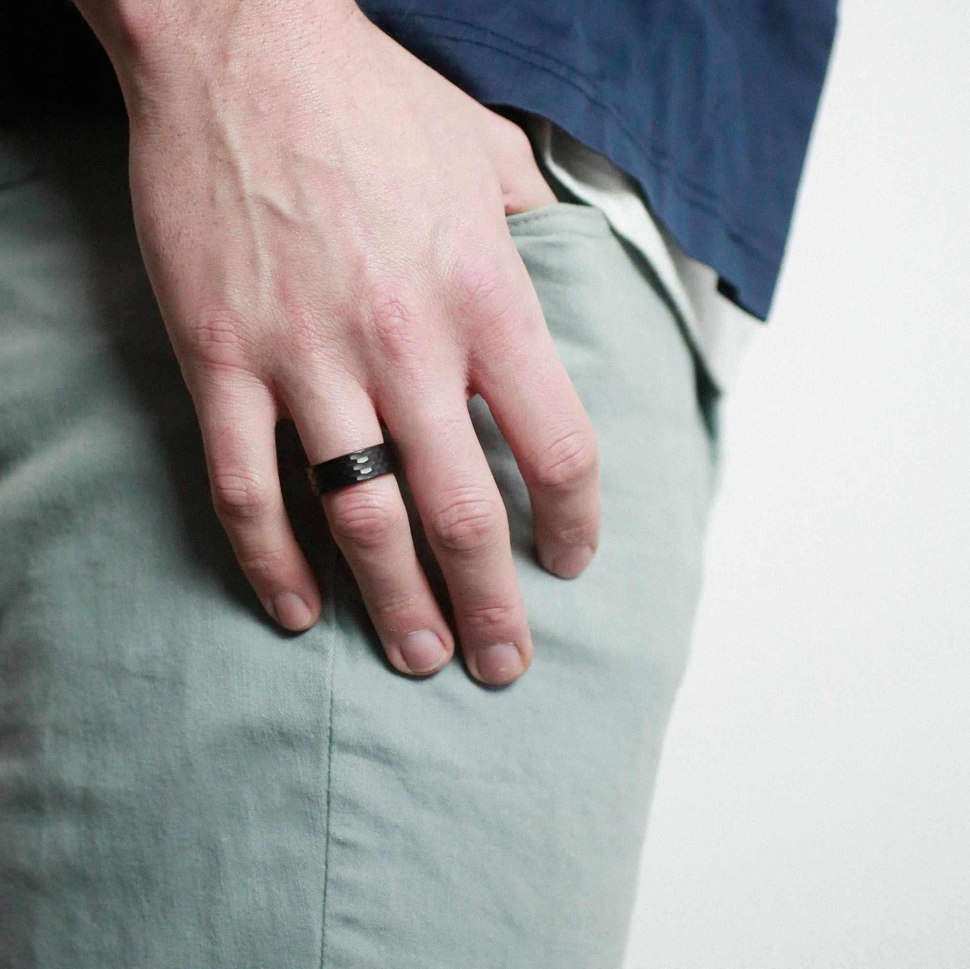 man with hand in pocket wearing a hammered tungsten wedding ring