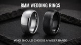 Black and silver 8mm men's wedding rings on a dark slate background