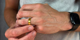 a man wearing a gold wedding band