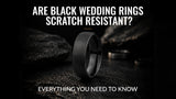 black tungsten wedding ring on a dark slate background showing its durable brushed finish