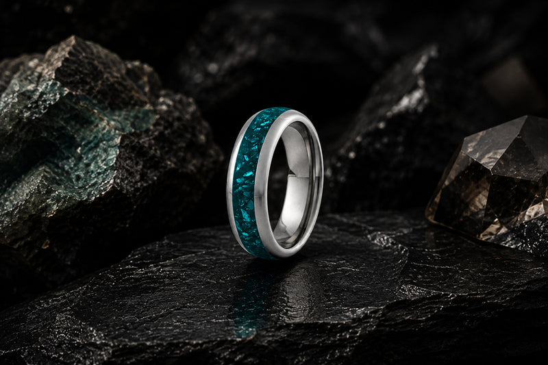 a lineup of coloured tungsten wedding bands with a vibrant turquoise inlay