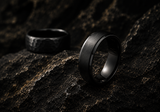 mens black rings photographed on a dark slate background