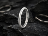 classic wedding bands photographed on a natural stone background