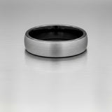mens two tone wedding ring photographed on a reflective metal surface