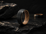 whiskey barrel and tungsten ring photographed on a whiskey barrel