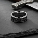 mens celtic tungsten wedding band photographed on slate