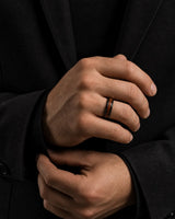 Man wearing a 4mm rose gold tungsten ring with a reddish-brown wood inlay.