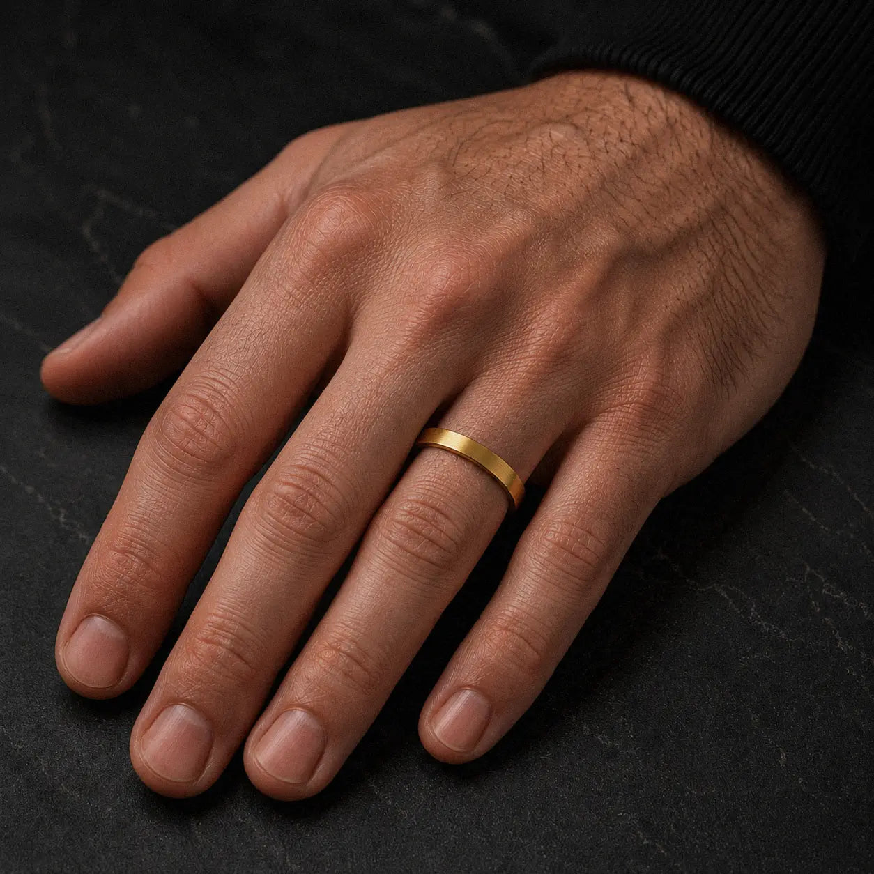 Man wearing a 4mm brushed gold tungsten wedding ring on his left ring finger