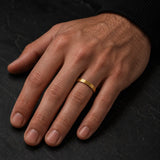 Man wearing a 4mm brushed gold tungsten wedding ring on his left ring finger
