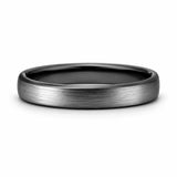 Brushed silver 4mm tungsten ring with polished black interior lying flat on a white studio background