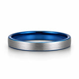 Brushed silver 4mm tungsten wedding ring with polished blue inner band lying flat on a white studio background