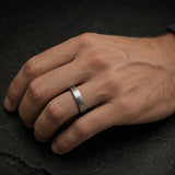 Man wearing a 4mm brushed silver tungsten wedding ring on his left ring finger
