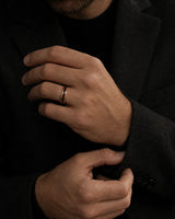 Man wearing a 4mm rose gold tungsten ring with a reddish-brown wood inlay.