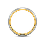Brushed silver 6mm tungsten wedding ring with polished gold inner band lying flat on a white studio background