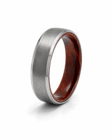 6mm brushed silver tungsten wedding ring with polished edges and genuine maple wood sleeve shown at an angled view on a white background.