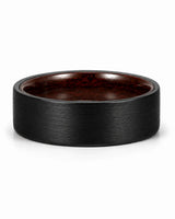 Low front view of a brushed black tungsten wedding ring with a maple wood sleeve interior.