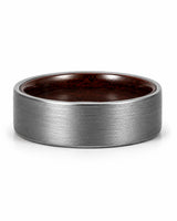 Low front view of a brushed silver tungsten wedding ring with a maple wood sleeve interior.