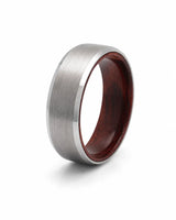Angled view of an 8mm brushed silver tungsten ring with polished edges and maple wood sleeve interior