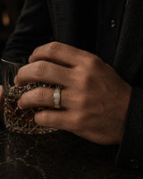 8mm gold meteorite inlay tungsten wedding ring worn by a man holding a crystal whiskey glass