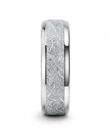 Angled view of 8mm silver tungsten wedding band with textured meteorite style centre and polished edges