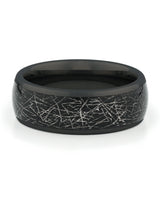 Close view of black tungsten ring with galaxy meteorite inlay
