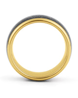 Gold galaxy and meteorite tungsten ring shown at an angle
