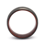 Side profile of a black beveled tungsten whiskey barrel wedding ring with a reclaimed maple wood interior.