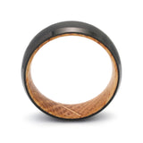 Side profile of a black beveled tungsten whiskey barrel wedding ring with reclaimed oak wood.