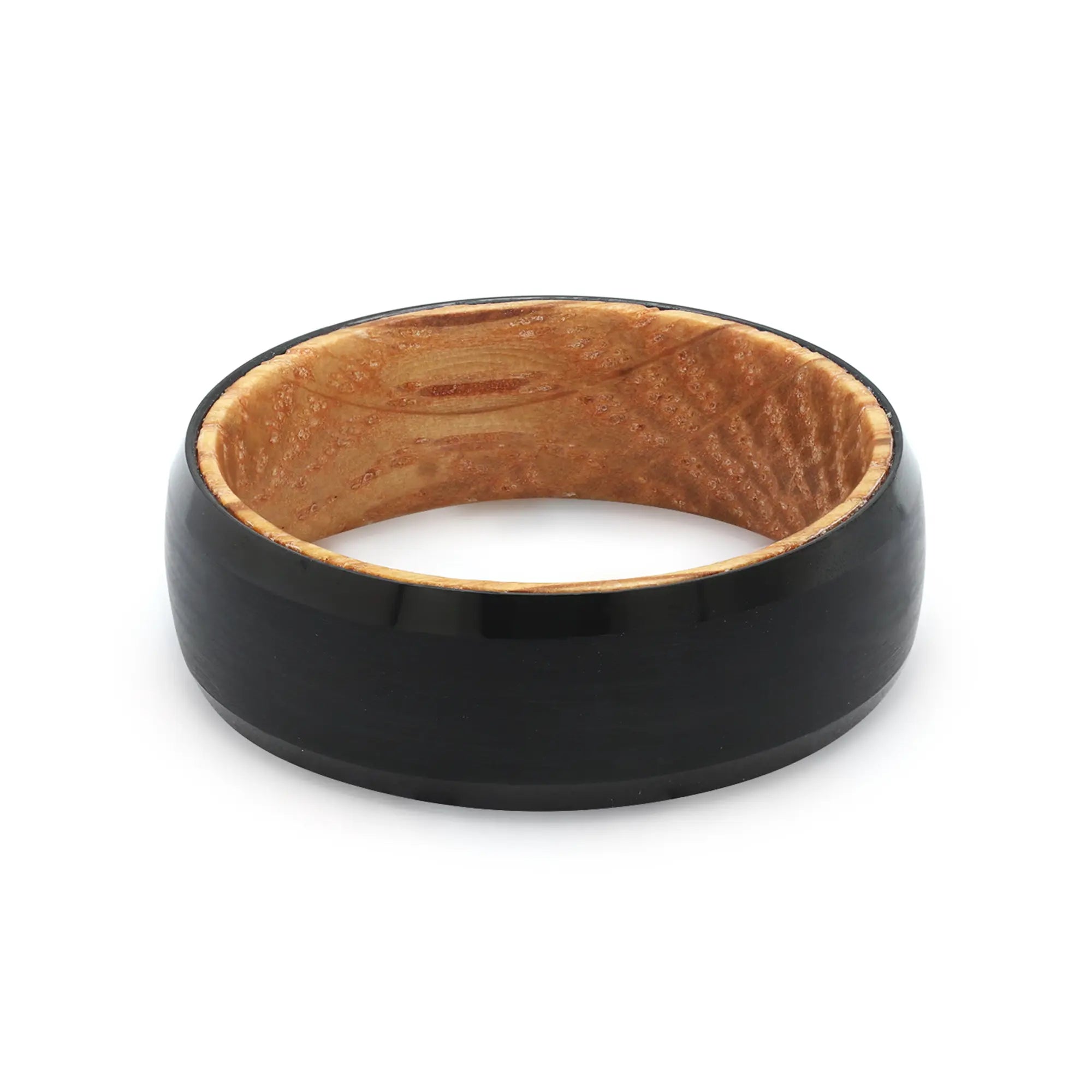 Top view of a black beveled tungsten wedding ring with a real oak whiskey barrel wood interior.