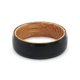 Top view of a black beveled tungsten wedding ring with a real oak whiskey barrel wood interior.