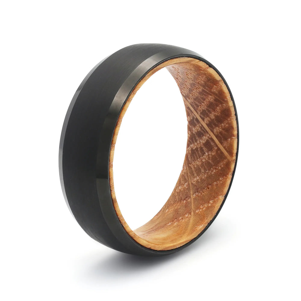 Black beveled tungsten whiskey barrel wedding ring with a real oak wood interior.