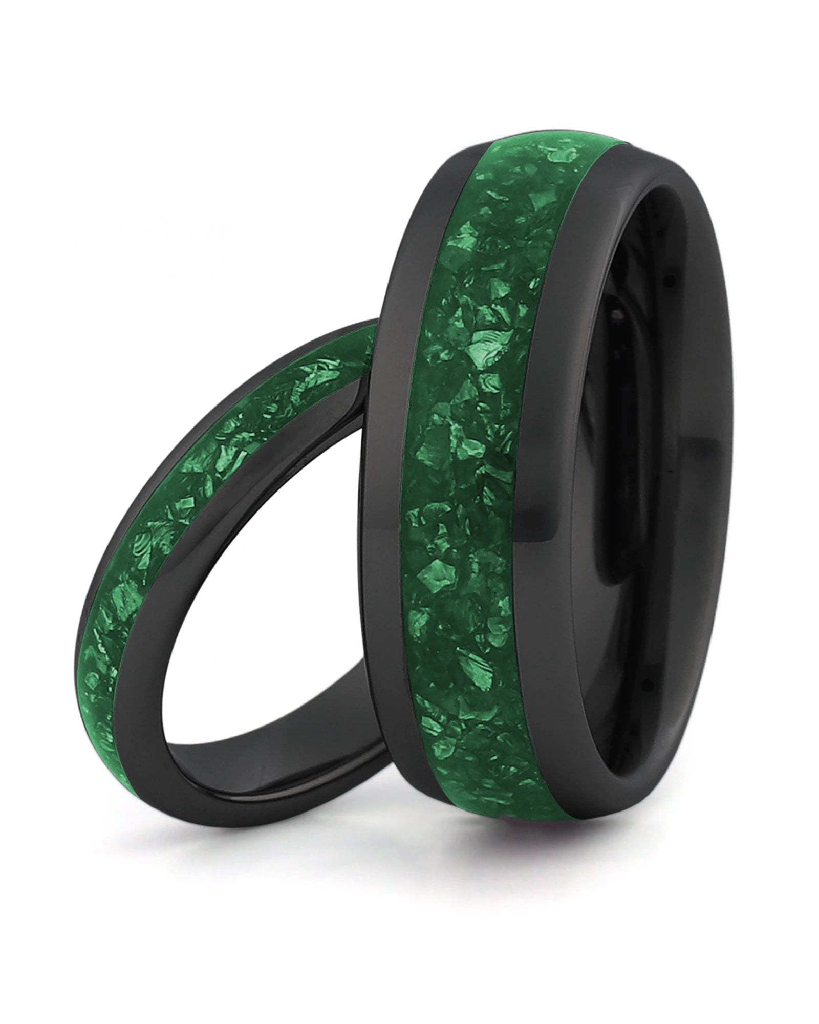 Matching black tungsten wedding rings with green emerald stone inlays